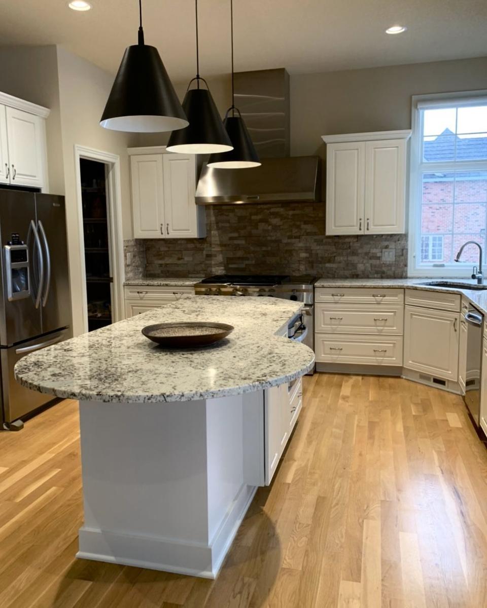White refinished cabinetry with oval island