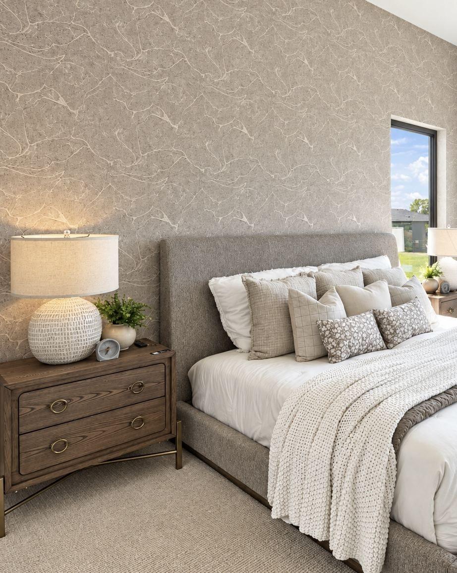 Textured wallpaper accent wall in primary bedroom
