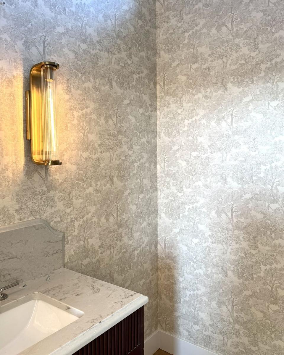 Toile wallpaper powder bath with brass sconce