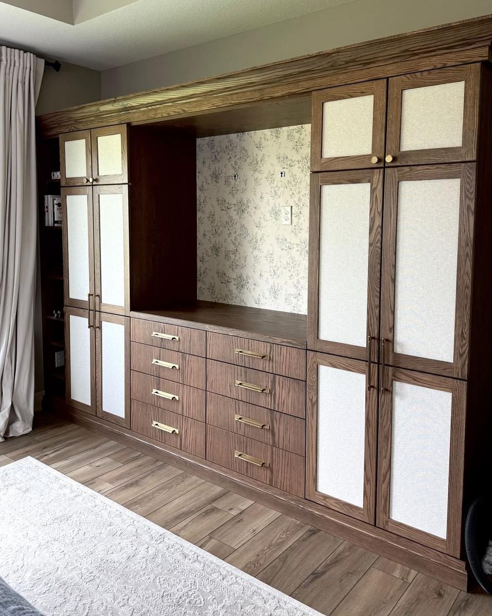 Built-in wardrobe cabinetry with wallpaper backdrop