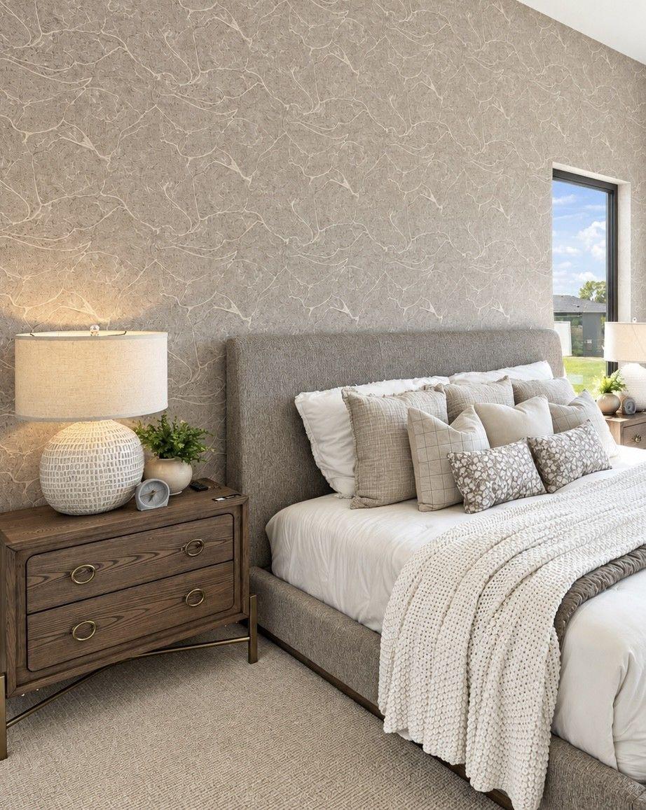 Textured wallpaper accent wall in primary bedroom