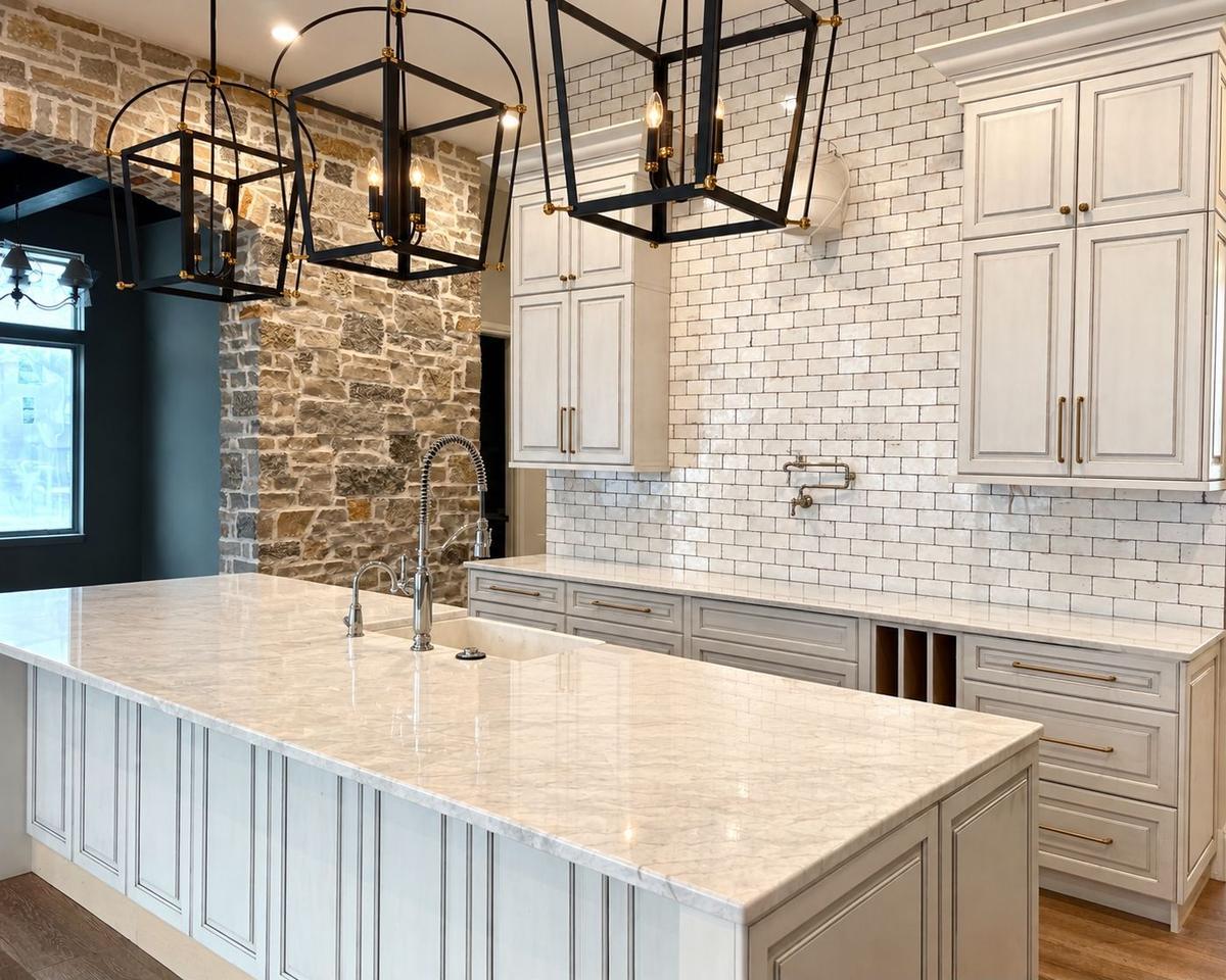 Glazed cabinetry with stone accent wall and subway tile