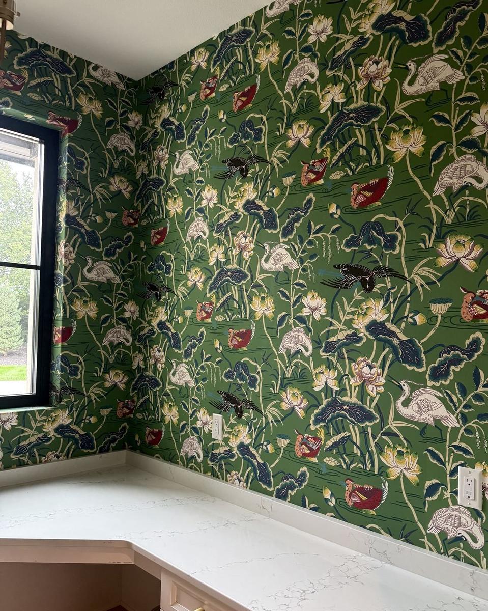 Green chinoiserie bird and lotus wallpaper corner