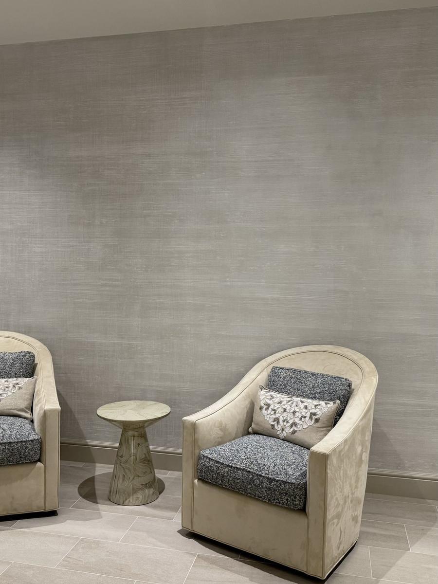 Soft gray linen-texture faux finish wall with swivel chairs